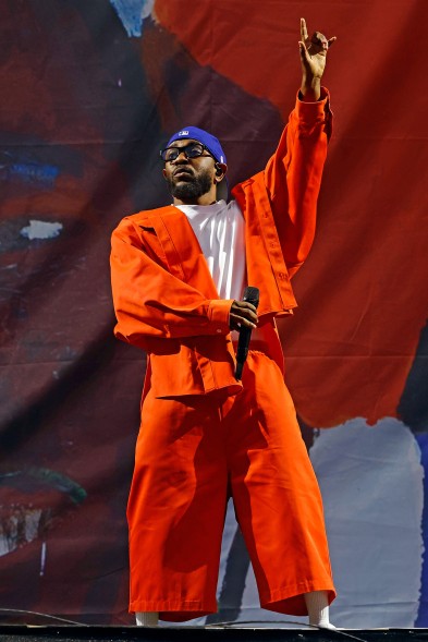 Kendrick Lamar wears orange during his performance at Governors Ball 2023.