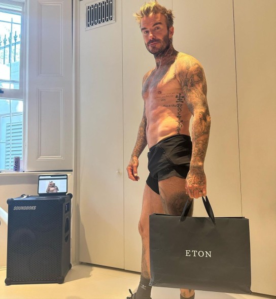 shirtless david beckham holding an Eton shopping bag